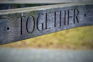 a sign saying together engraved in wood