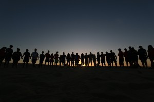 line of people sunset on hill