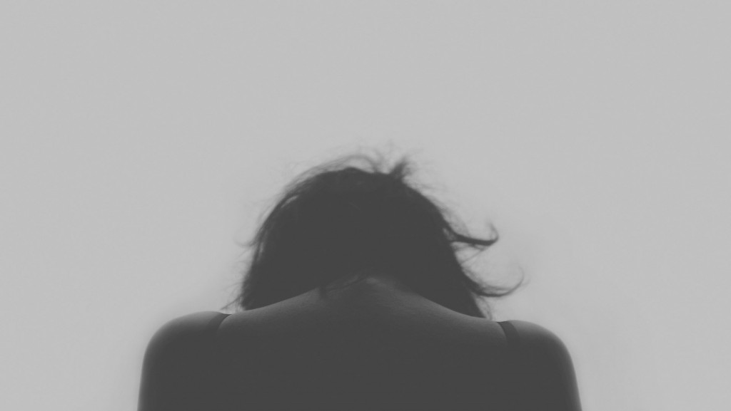 sad woman head down black and white