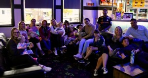 Group of smiling families sitting on benches at Rosemount Super Bowl