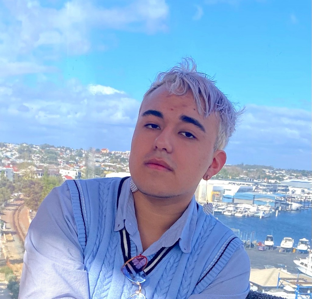 Young person Claudio, EIRP Participant standing with blue clouds in the background